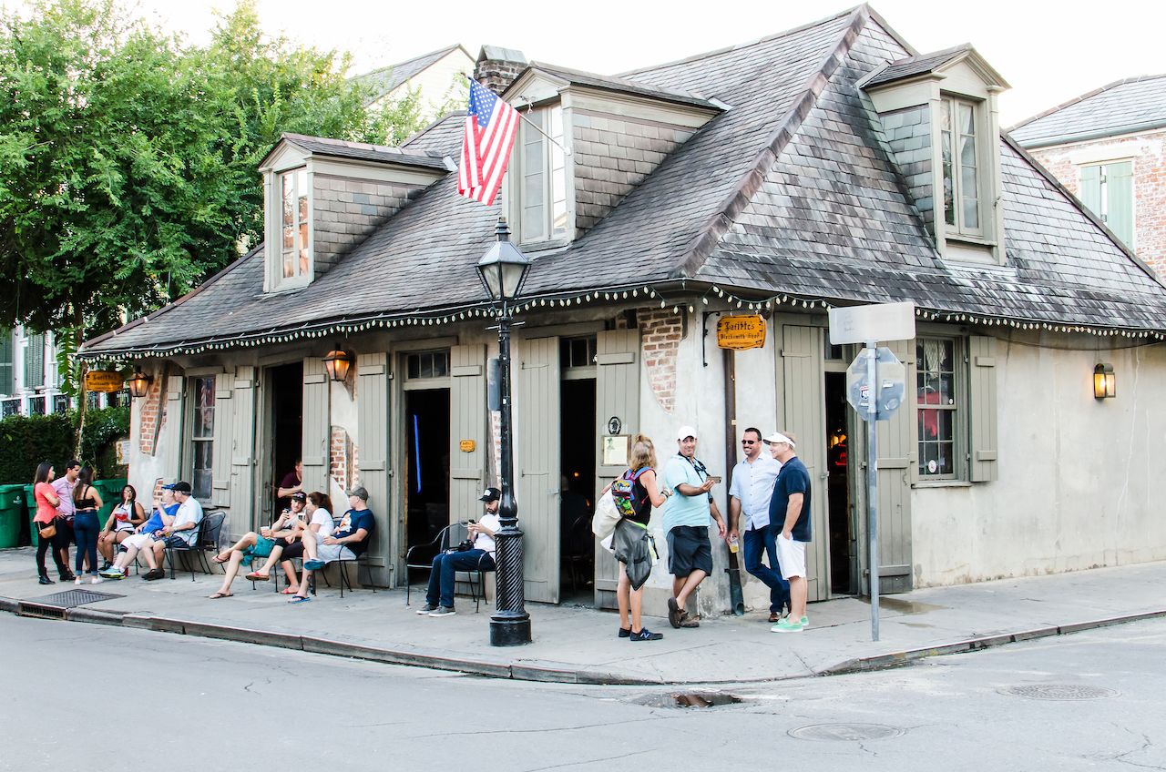 People sitting by Lafitte's blacksmith shop bar in New Orleans, Bourbon Street bars