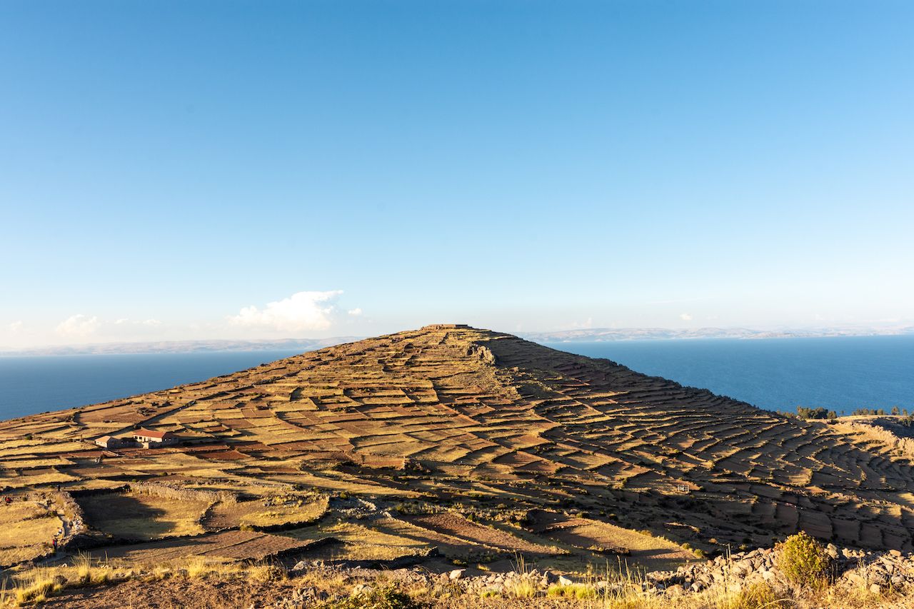 View of the Pachatata temple and it's small mountain from the Pachamama temple on AmatanÃ­ island, Puno, Peru., best hiking in Peru