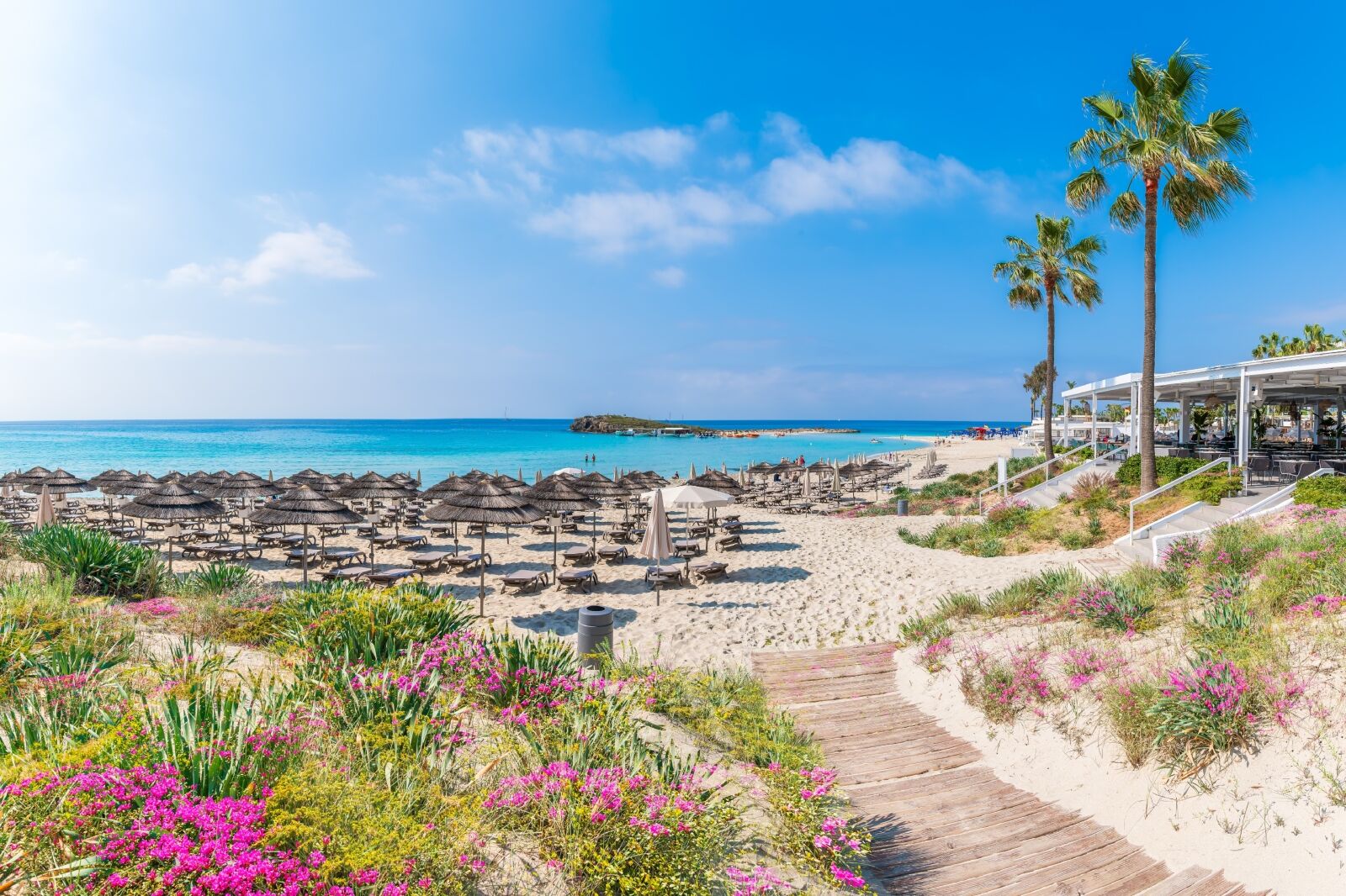 Discover the pristine Nissi Beach in Cyprus, a paradise with white sands and turquoise waters, perfect for relaxation, water sports, and family holidays