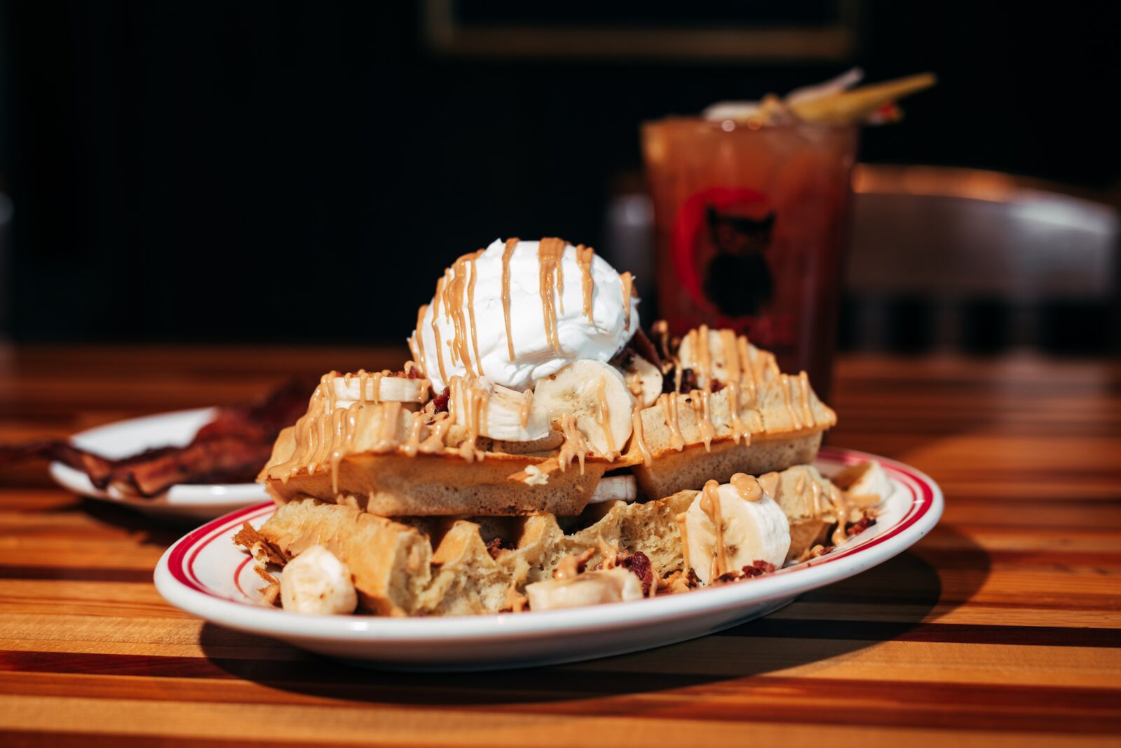 A plate of waffles topped with ice and syrip at ML Rose